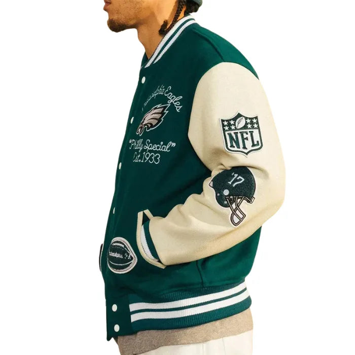 Green and beige varsity jacket with NFL logo and branding on a white background