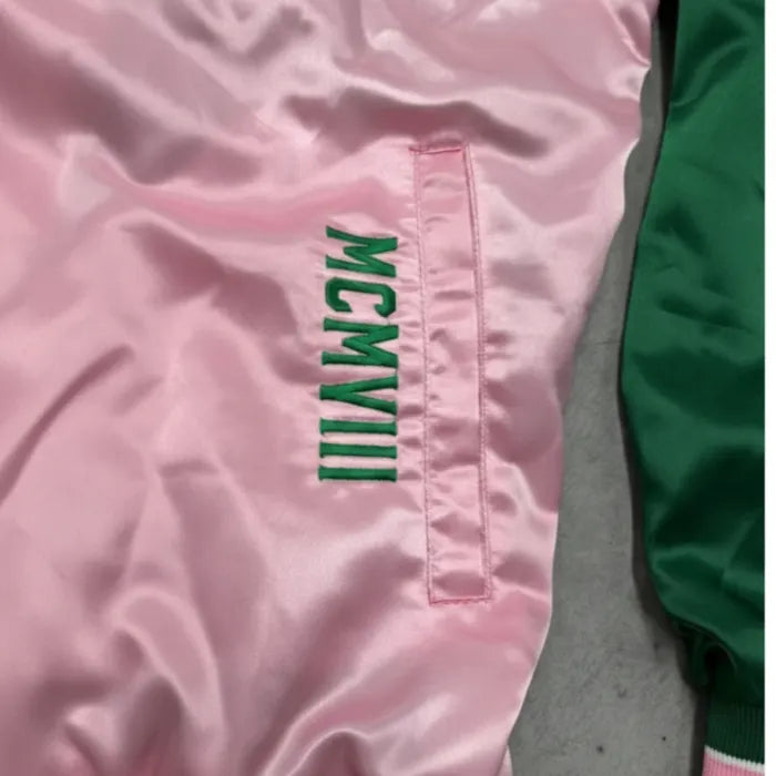 Pink jacket with green text on a pink background