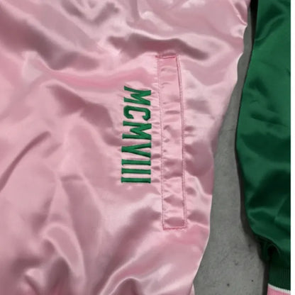 Pink jacket with green text on a pink background
