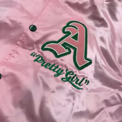 Pink jacket with green logo and text 'Pretty Girl' on a pink background