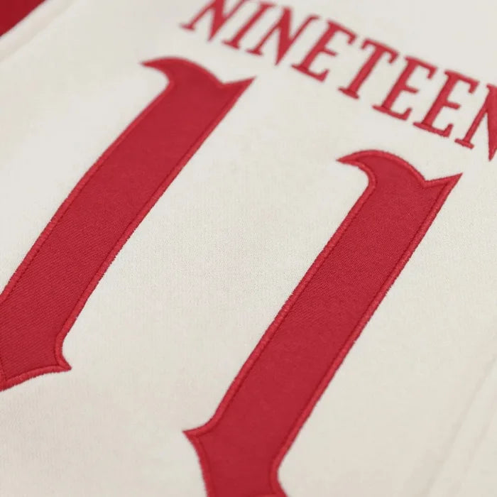 Close-up of a sports jersey with red lettering on a white background