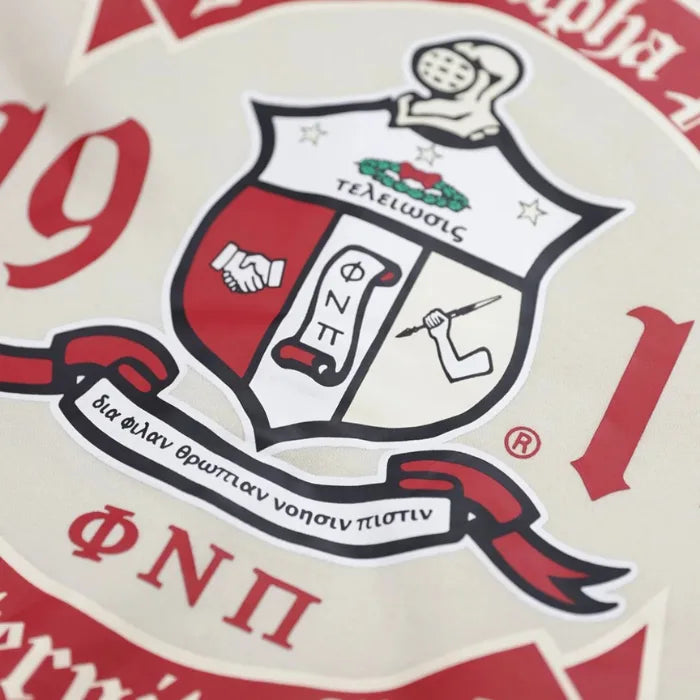 Close-up of a red and white emblem with text and symbols on a beige background