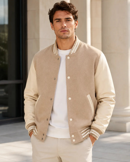Male model wearing a blank beige varsity jacket with cream leather sleeves, front view
