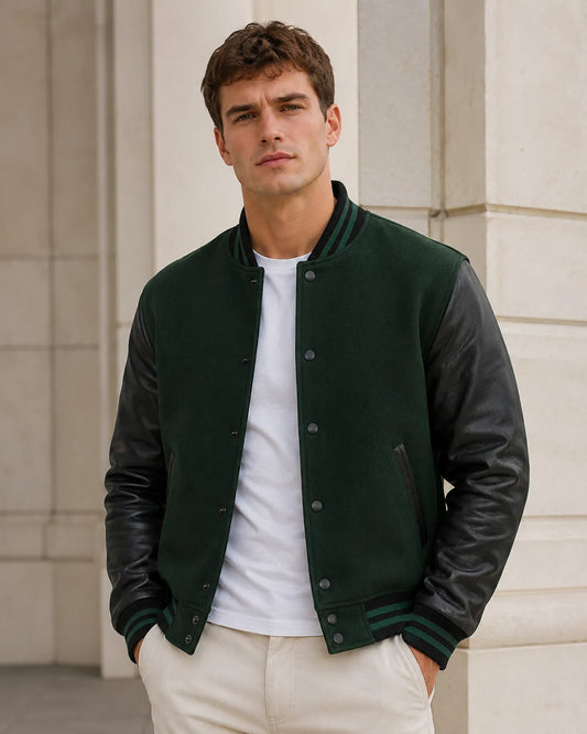 Male model wearing a blank men's black and green varsity jacket with black leather sleeves