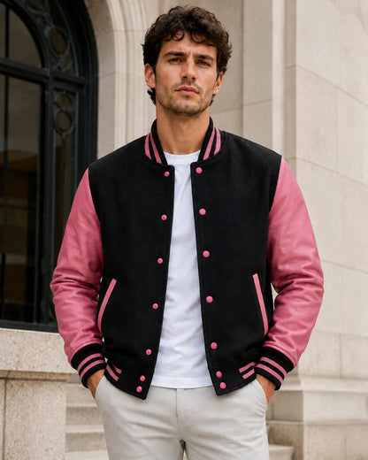 Male model wearing a blank men's black and pink varsity jacket with rose-pink leather sleeves