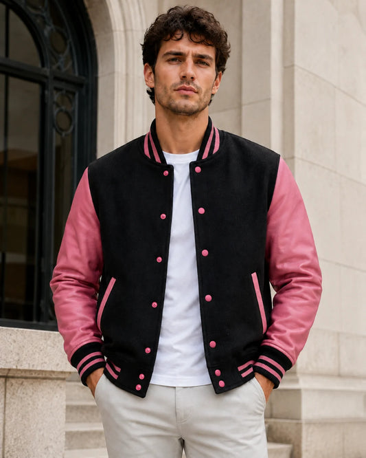 Male model wearing a blank men's black and pink varsity jacket with rose-pink leather sleeves
