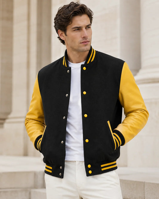 Male model wearing a blank men's black and yellow varsity jacket with yellow leather sleeves