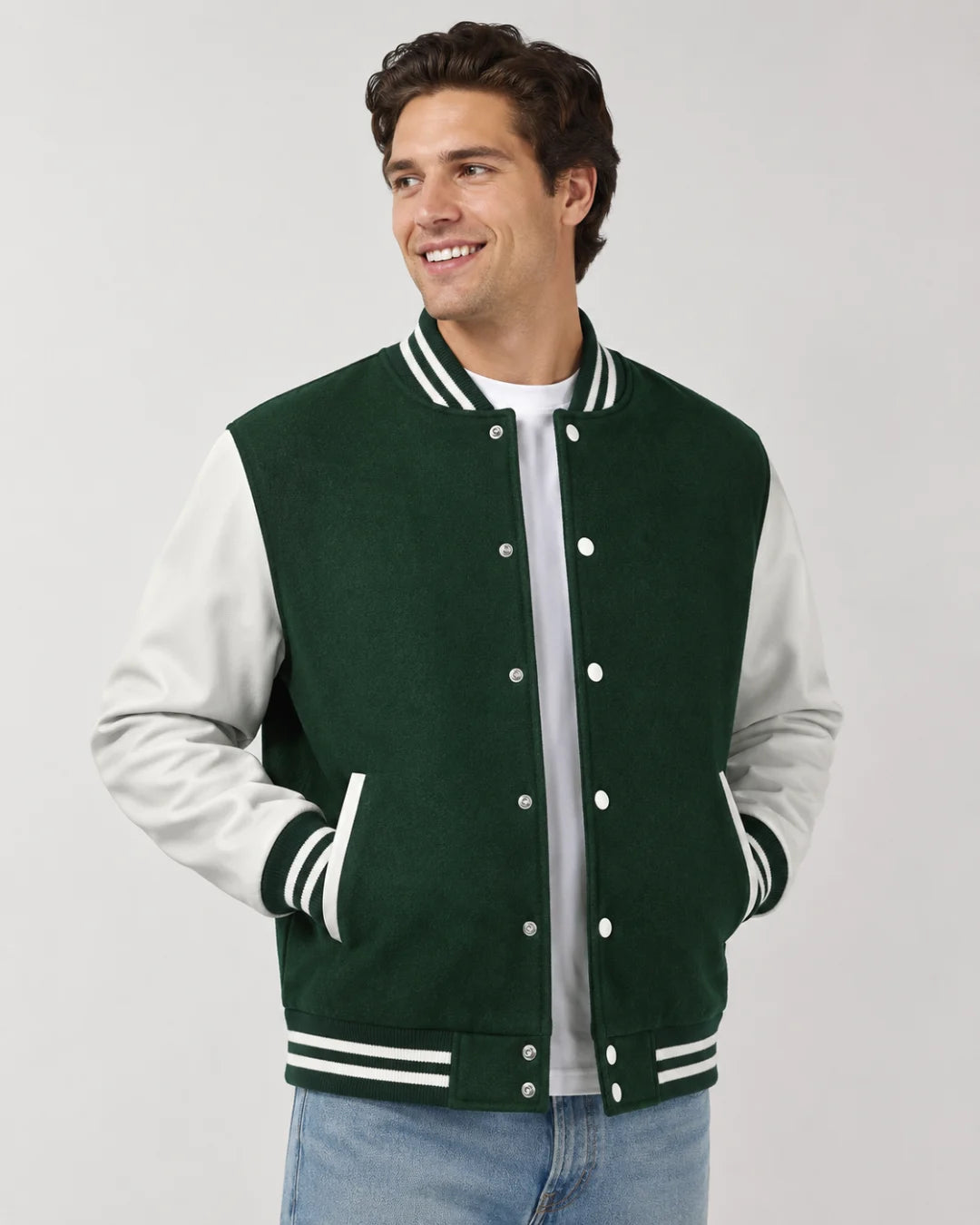 Mens green varsity jacket with wool body, white leather sleeves, snap buttons, and striped ribbed trim worn by male model