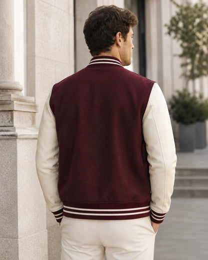Back view of a blank maroon varsity jacket with cream leather sleeves on a male model