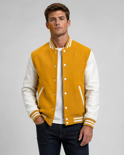 Mens yellow and white varsity jacket with wool body, white leather sleeves, snap buttons, and striped ribbed trim worn by male model