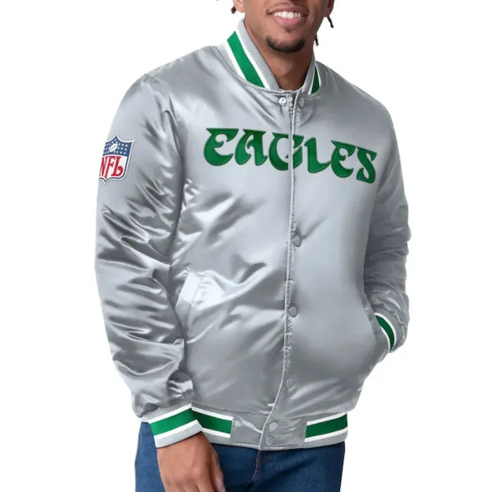 Person wearing a silver 'Eagles' jacket with green accents on a white background