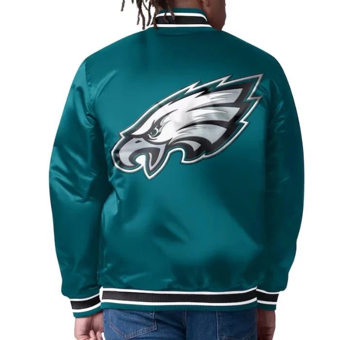 Teal jacket with eagle logo on the back, worn by a person