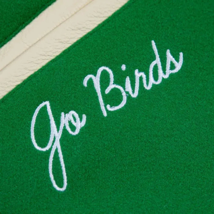 Close-up of a green fabric with 'go Birds' embroidered in white.
