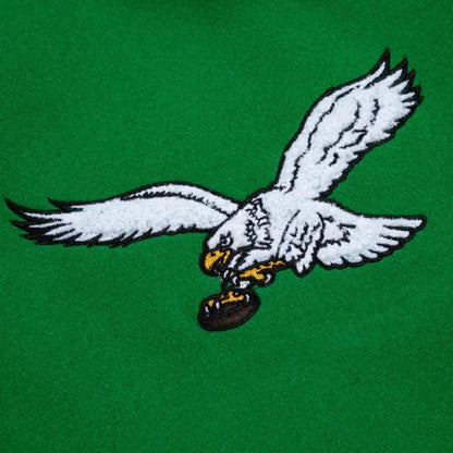 Embroidered eagle holding a football on a green background