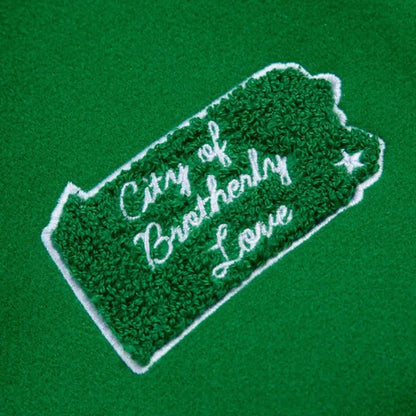 Embroidered patch with 'City of Brotherly Love' text on a green background