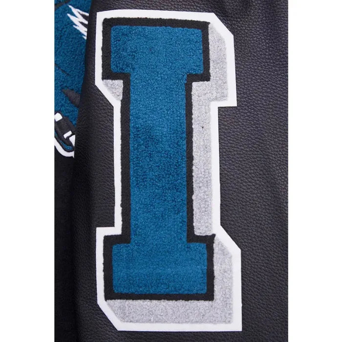 Close-up of a blue 'I' logo on a black background