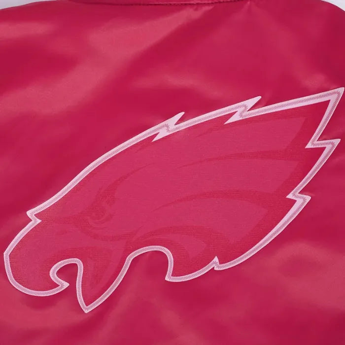 Close-up of a red jacket with a white logo on a red background