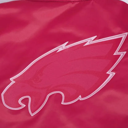 Close-up of a red jacket with a white logo on a red background