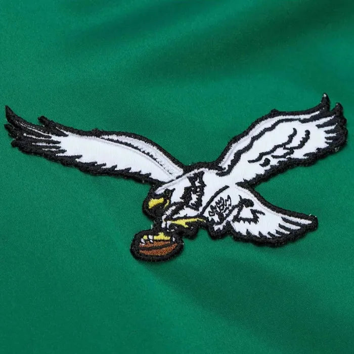 Embroidered eagle logo on a green background