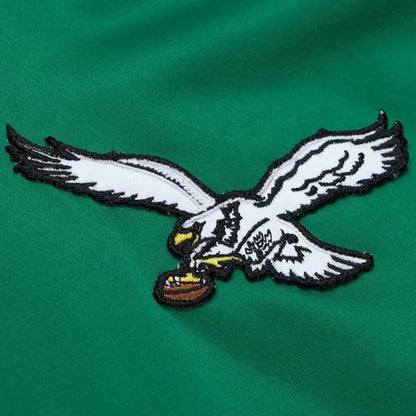 Embroidered eagle logo on a green background