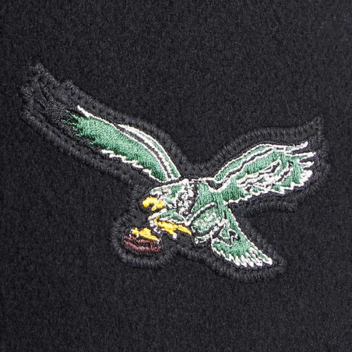 Embroidered eagle logo on a black background